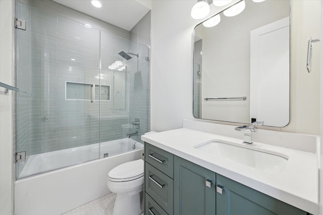 bathroom with toilet, bath / shower combo with glass door, and vanity