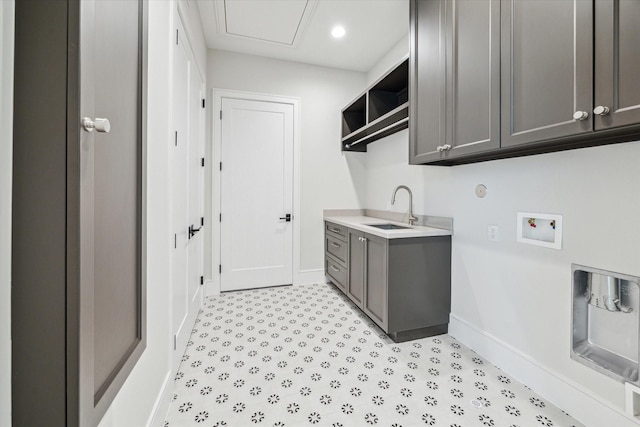 clothes washing area with recessed lighting, washer hookup, a sink, baseboards, and cabinet space