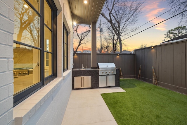 view of patio / terrace with a fenced backyard, area for grilling, and a grill