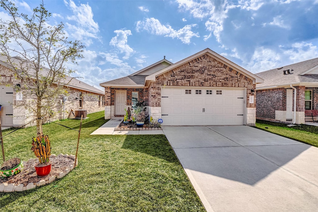 view of front of home with a garage, central AC, and a front yard