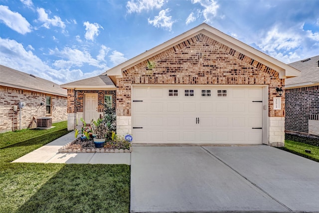 view of front facade featuring a garage, cooling unit, and a front yard