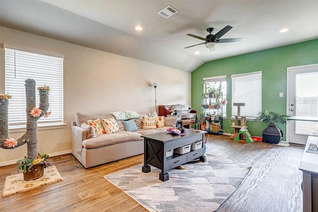 living room featuring ceiling fan, vaulted ceiling, and light wood-type flooring