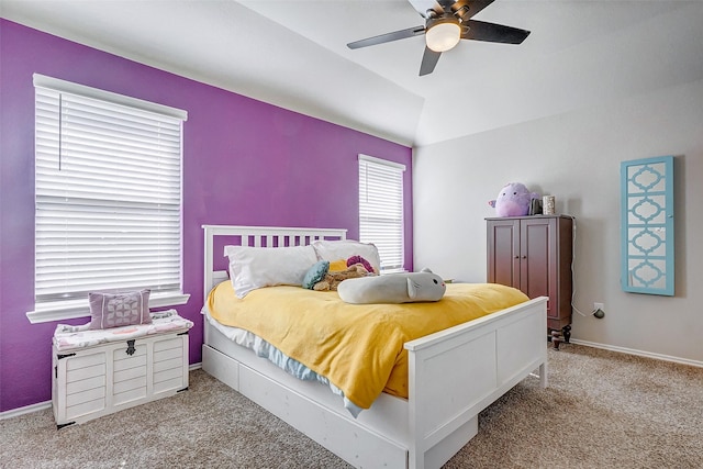 carpeted bedroom with ceiling fan and vaulted ceiling