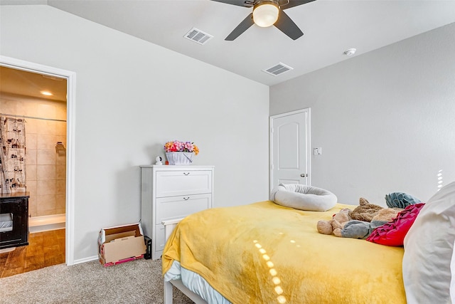 bedroom with ensuite bathroom, ceiling fan, and carpet