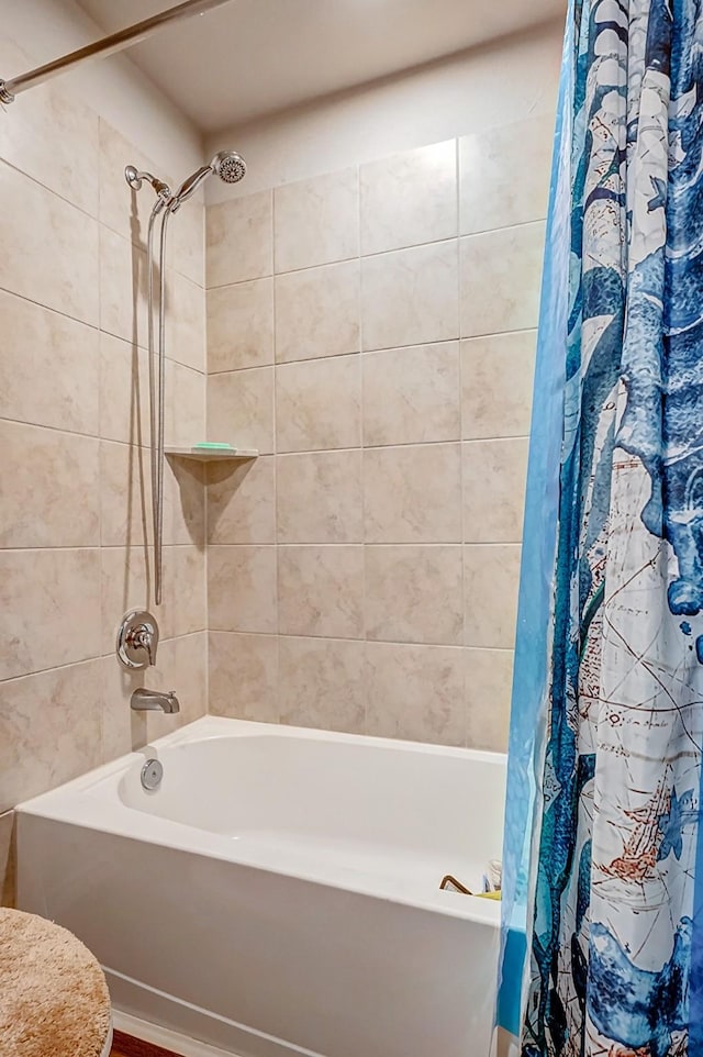 bathroom with shower / bathtub combination with curtain and toilet