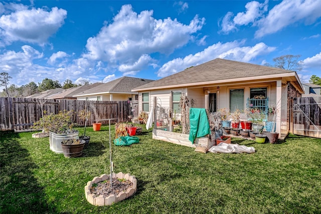 rear view of property featuring a lawn