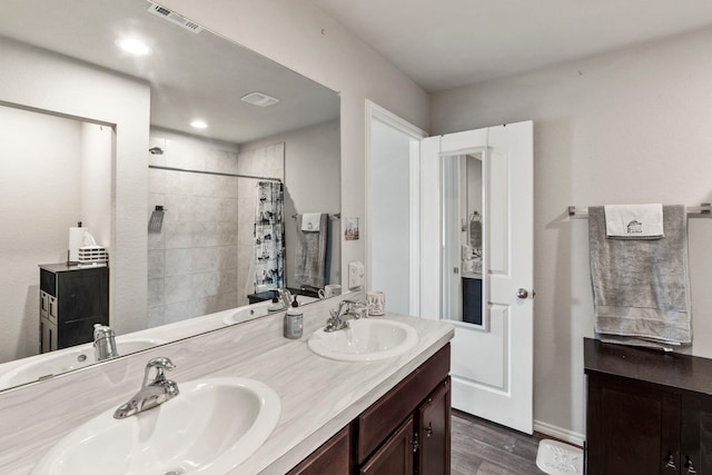 bathroom featuring vanity, wood-type flooring, and walk in shower