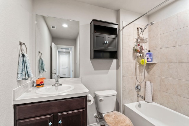 full bathroom with vanity, toilet, and tiled shower / bath combo