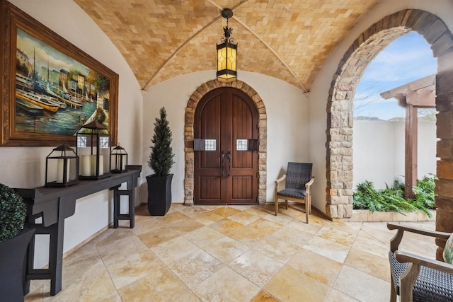 entryway with lofted ceiling and brick ceiling