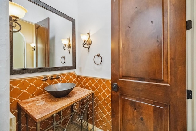 bathroom with tile walls and vanity