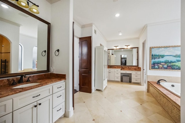 bathroom featuring vanity, tiled bath, and crown molding