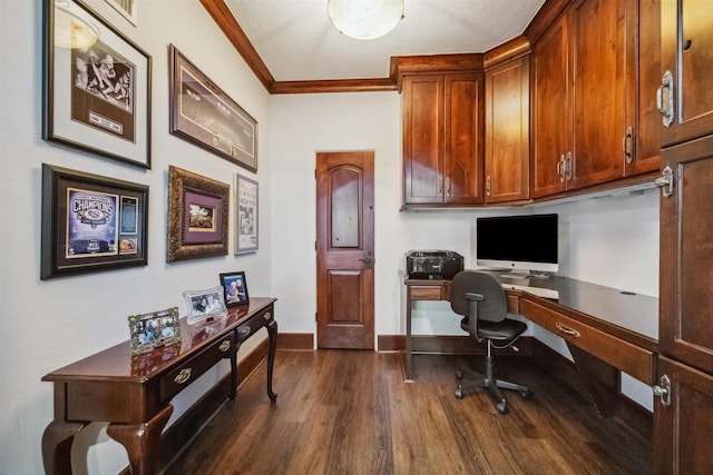 office space with dark hardwood / wood-style flooring, crown molding, and built in desk