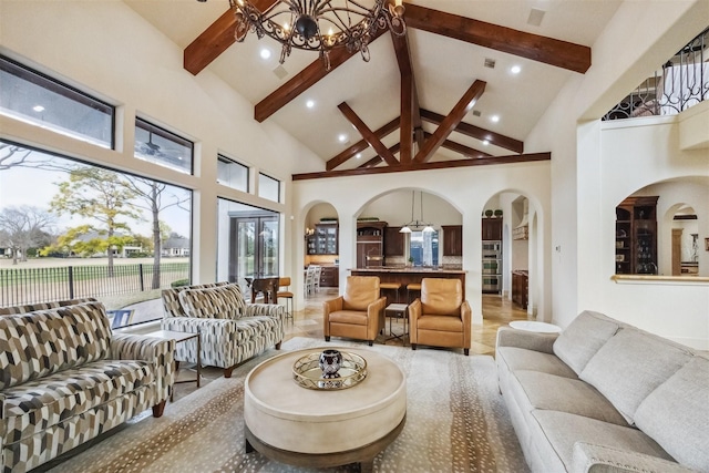 living room with beamed ceiling, high vaulted ceiling, and a chandelier