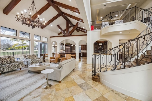 living room featuring an inviting chandelier, high vaulted ceiling, and beamed ceiling