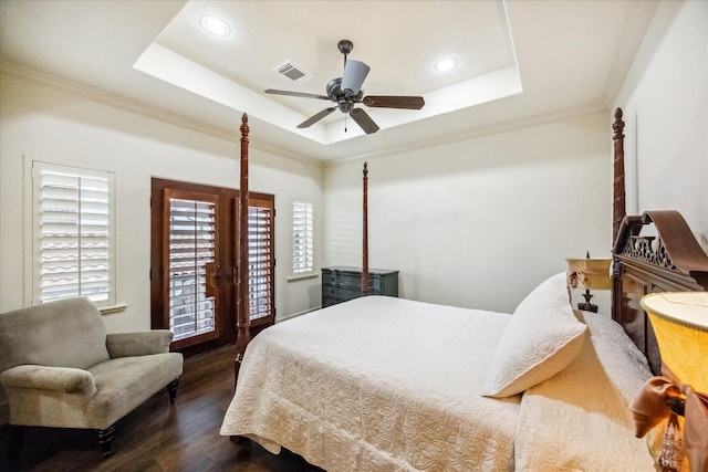 bedroom featuring ornamental molding, dark hardwood / wood-style floors, a tray ceiling, ceiling fan, and access to exterior