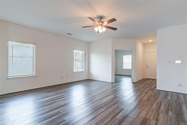 unfurnished room featuring ceiling fan, a healthy amount of sunlight, and dark hardwood / wood-style floors