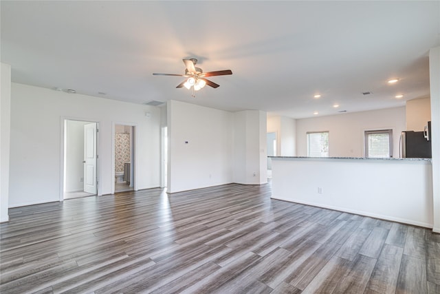 unfurnished living room with ceiling fan and wood-type flooring