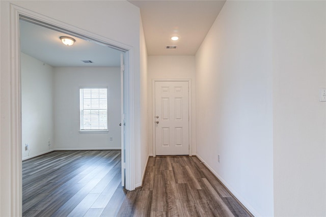 hall with dark wood-type flooring