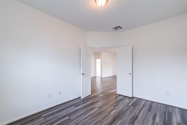 spare room featuring dark hardwood / wood-style floors