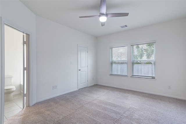 carpeted spare room featuring ceiling fan