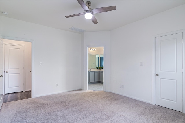 carpeted spare room featuring ceiling fan