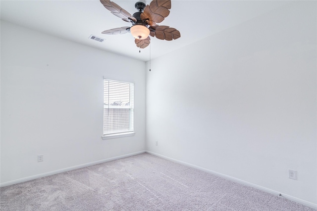 carpeted spare room with ceiling fan