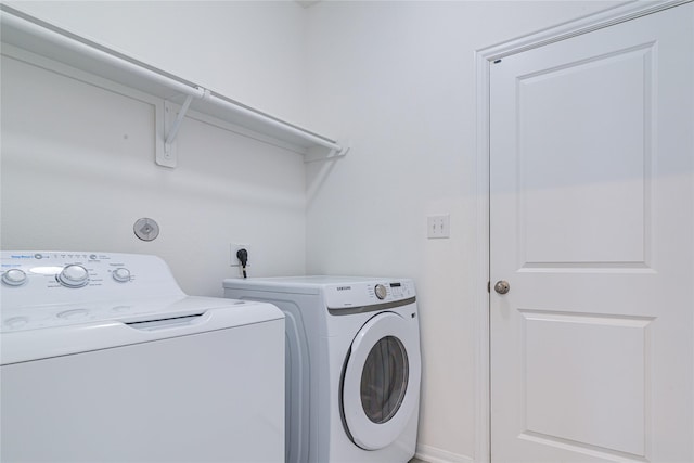 clothes washing area with washing machine and dryer