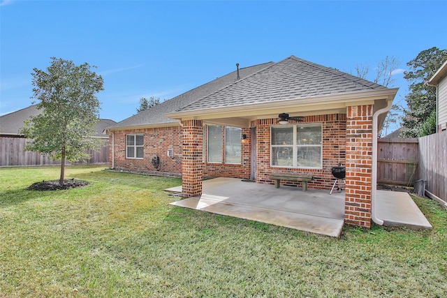 back of property with a patio, ceiling fan, and a lawn