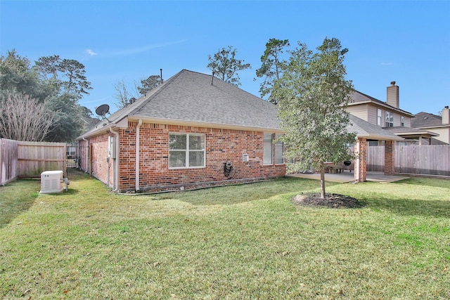 rear view of property with a patio and a lawn