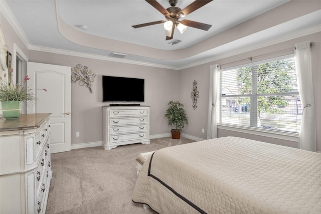 bedroom with a raised ceiling, crown molding, light carpet, and ceiling fan