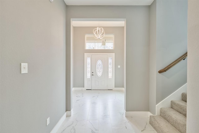 entrance foyer featuring a towering ceiling and a notable chandelier