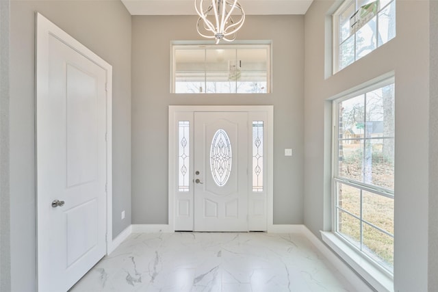 entrance foyer featuring an inviting chandelier