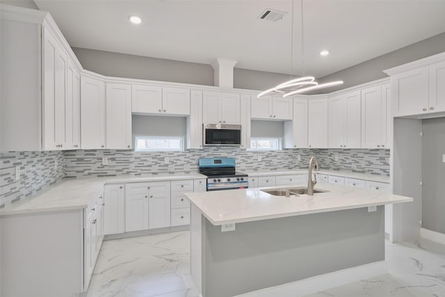 kitchen featuring sink, white cabinets, and appliances with stainless steel finishes