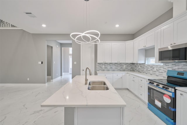 kitchen with appliances with stainless steel finishes, decorative light fixtures, sink, white cabinets, and light stone counters