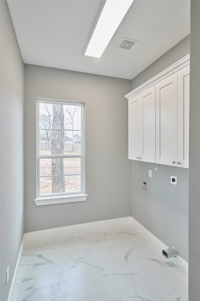 washroom featuring cabinets, a skylight, and hookup for an electric dryer