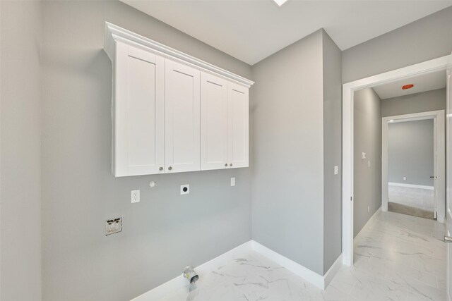 washroom with cabinets, gas dryer hookup, and hookup for an electric dryer