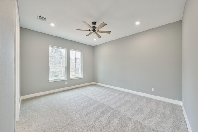 empty room with light colored carpet and ceiling fan