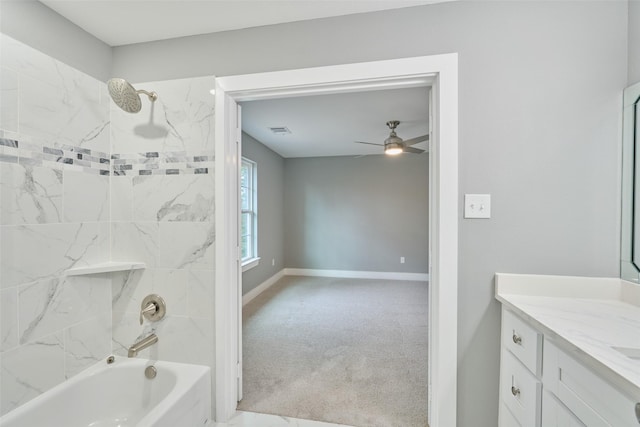 bathroom with vanity, tiled shower / bath combo, and ceiling fan