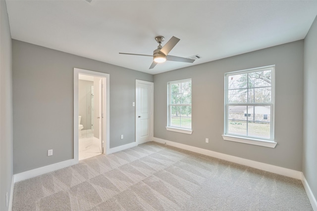 110 Broken Wheel Cir, Conroe, TX 77316 - unfurnished bedroom featuring baseboards, light colored carpet, ensuite bath, and a ceiling fan