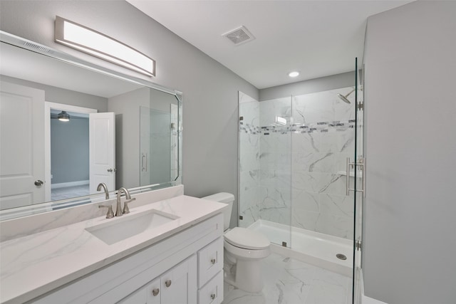 bathroom with vanity, a shower with door, and toilet