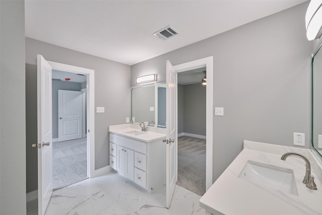 110 Broken Wheel Cir, Conroe, TX 77316 - bathroom featuring two vanities, baseboards, and marble look tile flooring