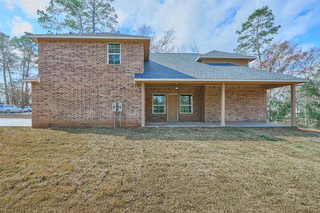 rear view of house with a yard and a patio area