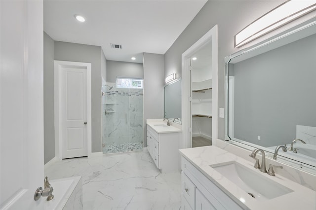 bathroom with vanity and shower with separate bathtub