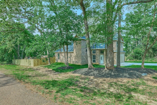 110 Broken Wheel Cir, Conroe, TX 77316 - view of front of property featuring fence, a garage, driveway, and brick siding