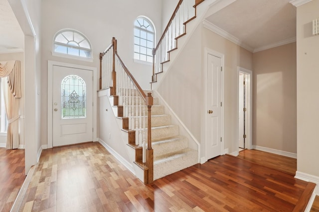 entryway with hardwood / wood-style flooring and ornamental molding