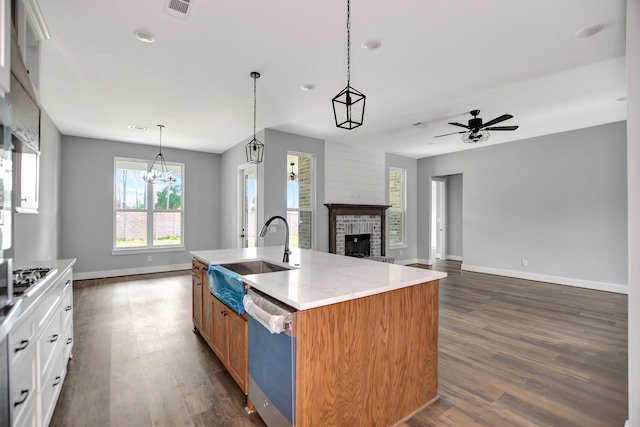 kitchen featuring sink, white cabinets, a kitchen island with sink, stainless steel appliances, and light stone countertops