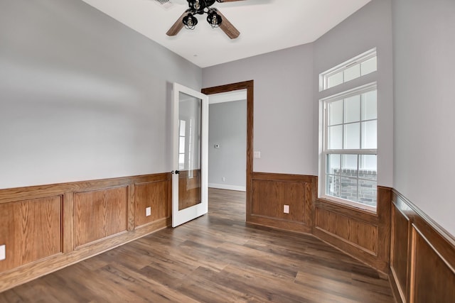 empty room with dark hardwood / wood-style floors and ceiling fan