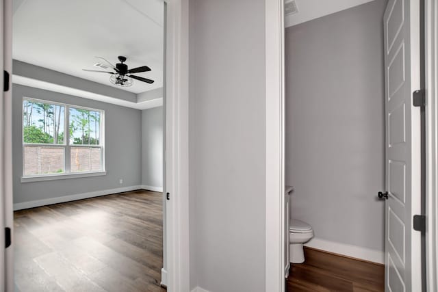 bathroom featuring hardwood / wood-style floors, toilet, and ceiling fan