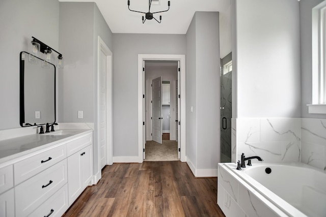 bathroom with vanity, hardwood / wood-style floors, and separate shower and tub