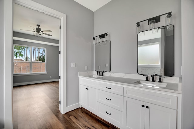 bathroom featuring hardwood / wood-style flooring, ceiling fan, and vanity